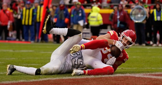 Kansas City Chiefs wide receiver Justin Watson, right, catches a touchdown pass as Las Vegas Raiders cornerback Nate Hobbs defends during the second half of an NFL football game Monday, Dec. 25, 2023, in Kansas City, Mo. (AP Photo/Charlie Riedel)