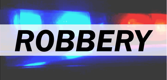 Police car light bar in the background with the word robbery overlaid in the center.